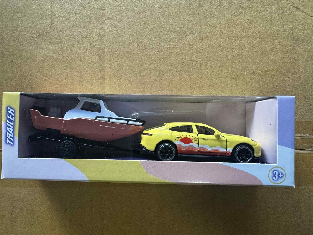 Drivez Yellow Sedan With Boat On Trailer